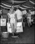 Primary view of [Young Girl Stomping Grapes at the Wine-Making Booth]