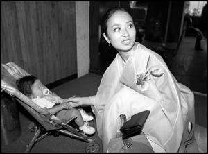 Primary view of object titled '[Miss Korea Visiting with a Baby]'.