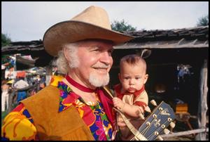 [Red River Dave Holding a Baby]