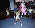 Photograph: [Child Swinging Stick at Piñata]