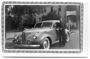 Primary view of object titled 'Buddy Sinclair with car 1941'.
