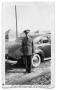 Thumbnail image of item number 1 in: 'Buddy Sinclair standing in uniform outside car'.
