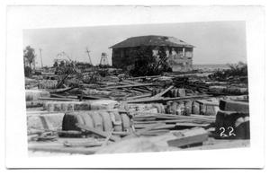 Primary view of object titled '[Photograph of House Surrounded by Debris]'.