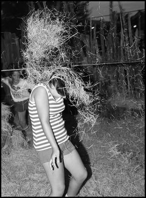 Primary view of object titled '[Girl Playing in Hay]'.