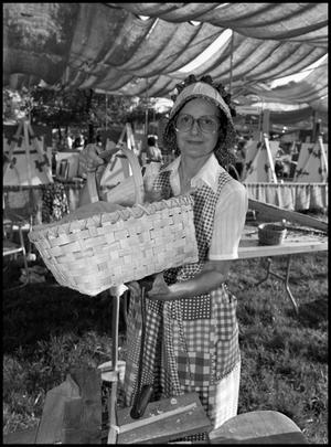 Primary view of object titled '[Virginia Munroe Holding a Basket She Made]'.