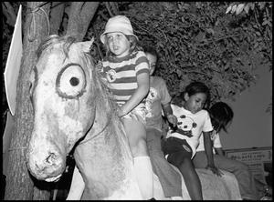 [Children Riding Artificial Horse]