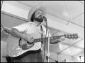 Photograph: [Lee McCullough Playing Guitar and Singing]