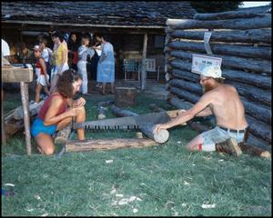 [Two People Sawing a Log]