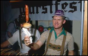 [Bob Goebel Serving German Sausage on a Stick]