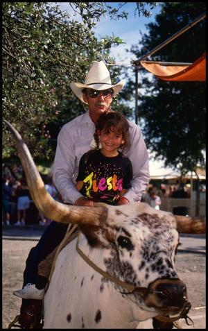 [Gary Henry and Child Riding Bubba the Longhorn]