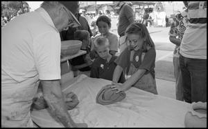 Primary view of object titled '[Master Potter Pete Payne Showing Kids How to Work Clay]'.