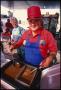 Photograph: [Melvin Breaux Serving Shrimp Gumbo at Texas Cajun Club Food Booth]