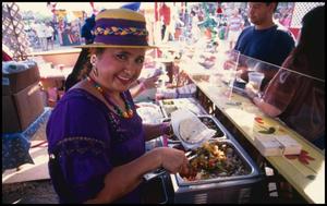 [Woman serving tacos at the St. Alphonsus Catholic Church Food Booth]