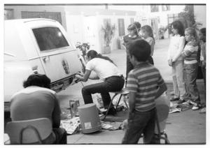 Primary view of object titled '[Prepping a Vehicle for Día de los Muertos Celebrations]'.