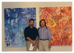 [Two Artists Standing in Front of Paintings]