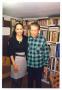 Photograph: [Jose Cisneros and Sylvia Orozco Next to Bookcase]