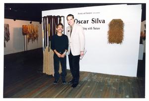 Primary view of object titled '[Oscar Silva and Jorge Sedeño in Front of Title Wall]'.