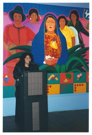 Primary view of object titled '[Hispanic Woman Speaking Behind a Podium]'.
