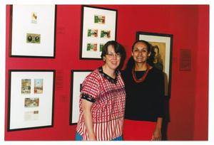 [Two Women Standing in Front of a Red Gallery Wall]