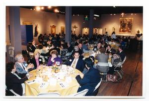 [People Seated at Banquet Tables in a Gallery]