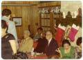 Primary view of [Men and Women Seated at Tables During Christmas Party]