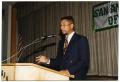 Photograph: [Man in Glasses Speaking at Salute to Youth Awards Program]