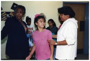 [Girl in Pink with Teachers at Martin Luther King Middle School]