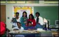 Photograph: [Women Presenting Books with Gates Elementary Students]