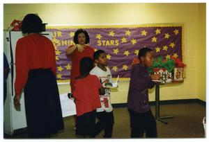 [Deborah Crawford and Students with Food During Christmas Party]