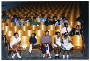 [Children and Adults Sitting in Auditorium During Health Fair]