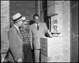 Photograph: [Men examining brickwork at St. Paul's Lutheran School]