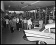Photograph: Showroom with crowds, 5th & Lamar