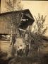 Primary view of Railroad Survey Crew Member in Front of Covered Bridge, c. 1902