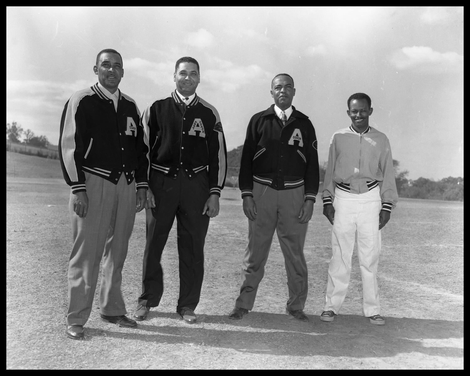 Four Coaches in Letterman's Jackets]