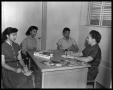 Photograph: [Four Women Sit at a Desk]