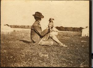 Railroad Survey Crew Member Holding a Dog, c. 1902