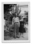 Photograph: [Marie Burkhalter stands with a man on a walkway]