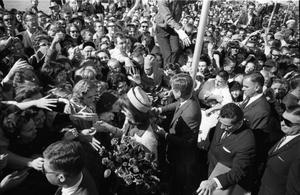 [President and Mrs. Kennedy greeting crowds at Love Field]