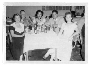 Marie Burkhalter sitting at a table with a group of people