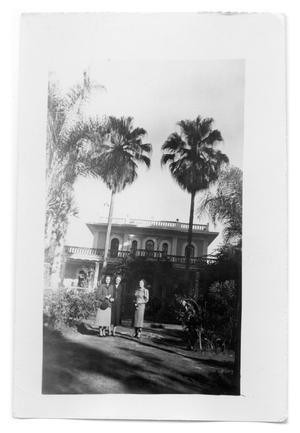 [Photograph of Women Standing in Front of House]