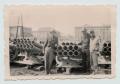 Photograph: [Men Standing with Captured Mounted Rocket Launchers]