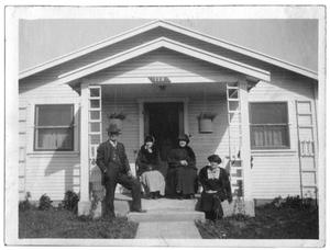 Four people at the entrance to a house