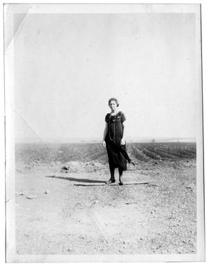 Woman standing in front of a crop field