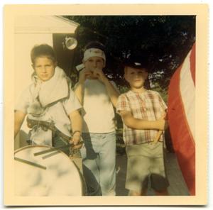 Three boys in a Fourth of July parade