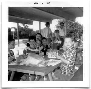 Group of school boys sitting at a picnic table