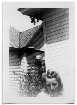 Woman standing outside of a house
