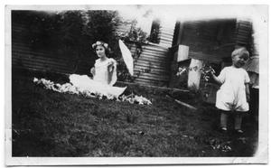 Elizabeth Wilken and L.G Cox in the front yard of a house