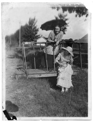 Elizabeth Scrivner and another woman stand on a small bridge