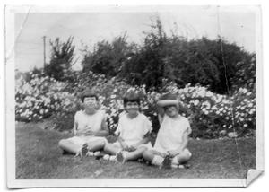 The Vise children sitting together in the grass