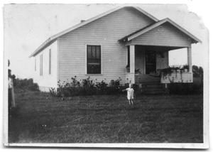 Primary view of object titled 'L. G Cox in front of Daisy Johnson's house'.